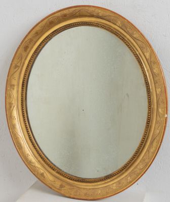 an image of a gold framed mirror sitting on top of a white shelf