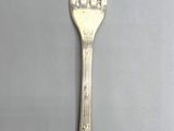 a silver fork and a silver spoon on a table