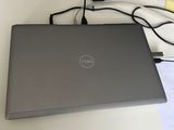 laptop on a desk with a mouse, keyboard, and mouse pad