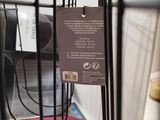a black wire rack with a sign on it