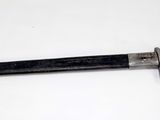 a knife that is laying on a white surface
