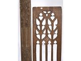 a pair of carved wood doors with decorative designs