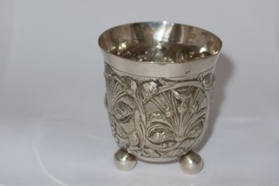 a silver cup that is sitting on a table