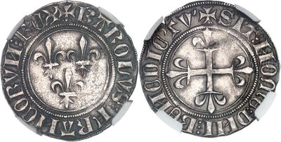 a close up of a coin with a cross on it
