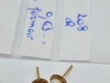 a pair of pearl and gold earrings on a piece of paper