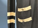 an image of a black coat with gold trims and buttons
