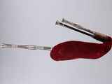 a pair of scissors and a red bag on a table