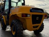 a yellow tractor that is parked in a parking lot