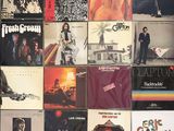 a lot of records on the wall of a room