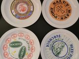four different types of paper plates with different logos on them