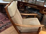 a chair that is sitting in a room with a rug on the floor