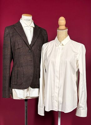 two shirts on a mannequin stand next to each other