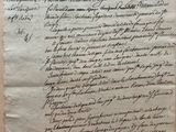 an old document with writing on it sitting on top of a table