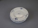 a stack of blue and white plates sitting on a table