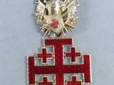 an image of a medal with a cross on a black ribbon