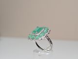 an image of a ring with a green stone on top of it