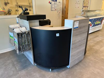 a black and white counter in a store with a lot of items on it