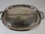 a silver tray with a handle on a white table