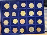 someone is holding a box of gold coins in their hands