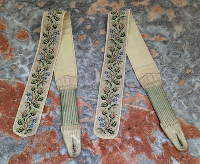 two pieces of cloth with floral designs on them sitting on a marble surface