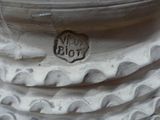 a close up view of a white pillar with a stamp on it
