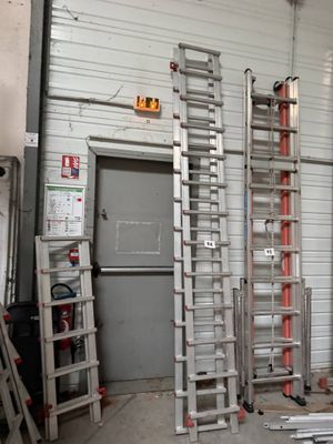 many ladders that are stacked up in a room