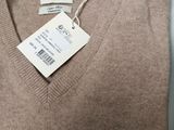 a close up of a sweater with a tag on it