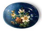 a blue plate with a painting of flowers on it