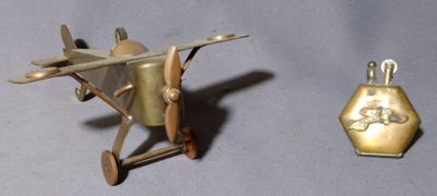 a small toy airplane next to a small gold object