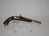 an old gun on a clear stand on a white surface