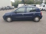 a small blue car parked in a parking lot