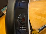 a close up of a person ' s foot with a pair of shoes next to a computer