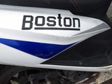 a white and blue motorcycle parked on the side of the road