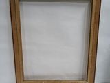 an old picture frame sitting on top of a white table