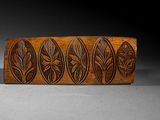 a close up of a wooden box with carvings on it