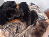 several furs laid out on a wooden table