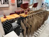 tables and chairs are lined up in a row in a restaurant