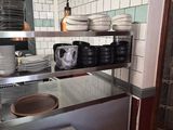 a kitchen with a lot of plates and bowls on the counter
