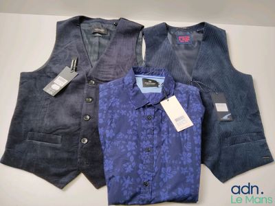 three men ' s vests are lined up on a table