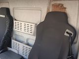 two seats in the back of a van with a seat cover