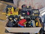 a box full of legos sitting on a couch