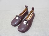 pair of women ' s shoes with a bow on the side of them