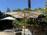 an image of a patio area with a pool and lounge chairs
