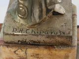 statue of a woman holding a glass of wine on a marble base