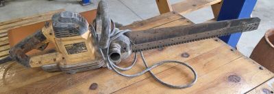 a chainsaw sitting on a wooden table in a workshop