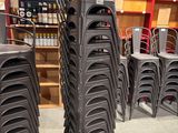 many chairs that are stacked on top of each other