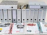 several binders are stacked on top of each other on a table