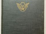 a green book with a gold emblem on the cover