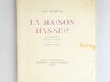 an old book with a pink cover on a white surface