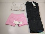 two pieces of clothing on a table next to a pair of shorts